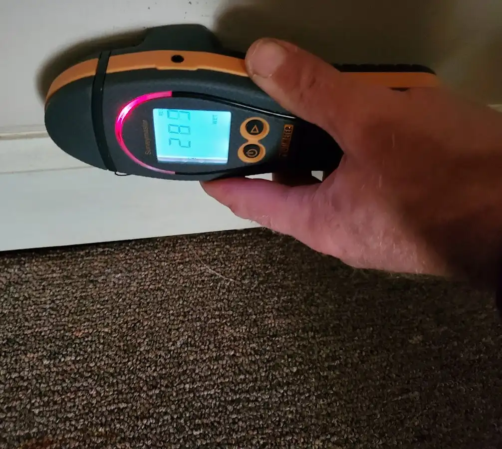 Moisture detection at baseboard during Storm Damage Restoration in Hiram